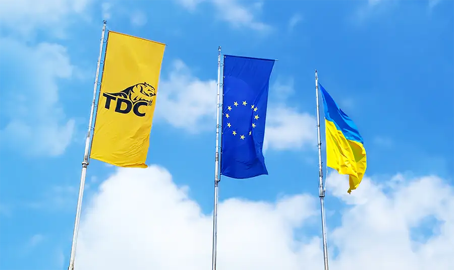 flags of TDC, EU and Ukraine with sky on the background